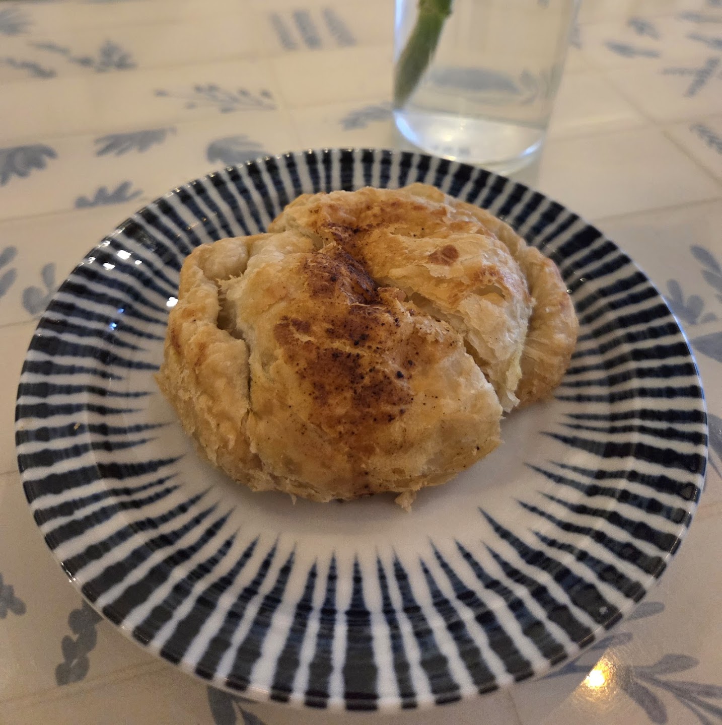 Whole flaky pastry on patterned plate at Moments