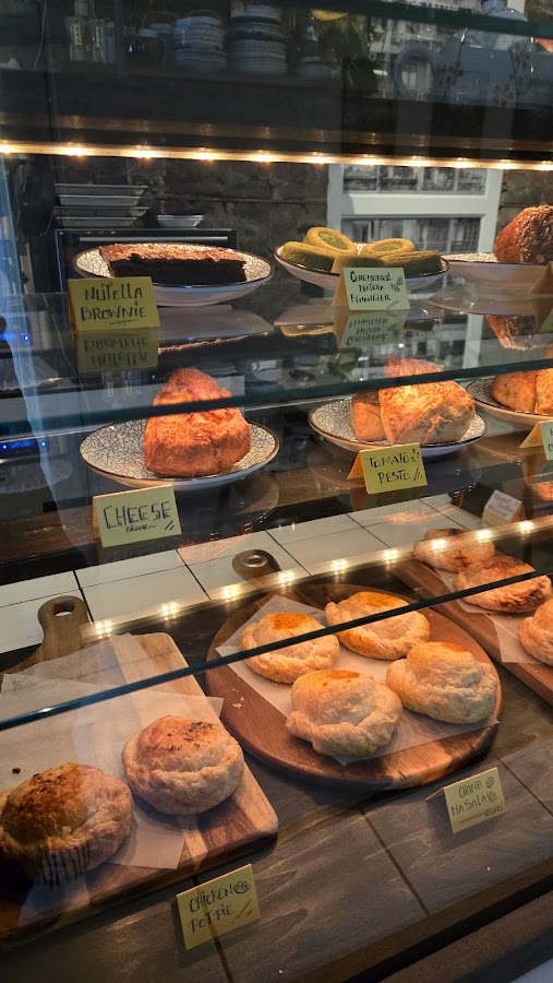 Fresh pistachio scones and pastries in Moments bakery case